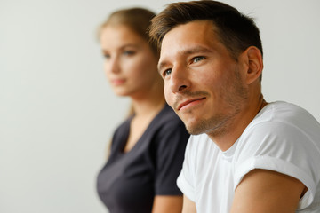 Close-up portrait of yoga trainer in white t-shirt.