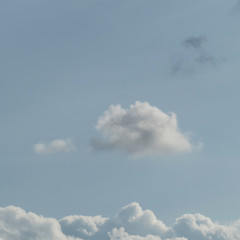 One fluffy cloud floating above other clouds. Dreamy background for concepts of love. To float on cloud nine.