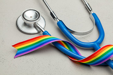 Stethoscope and LGBT rainbow ribbon pride symbol. Medical support after sex reassignment surgery....