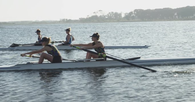 Female rowing team training on a river