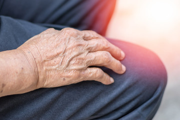 Parkinson and Alzheimer female senior elderly patient with caregiver in hospice care. Doctor hand with stethoscope check up older woman people. Old aging person seeing medical physician in hospital.