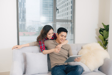 Just married couple of young man and woman feeling unbelievable chilling in their new house