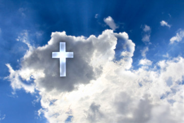 Cross from the blue sky against a background of dark clouds