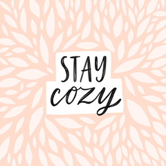 Stay cozy Hand written lettering quote. Cozy phrase for winter or autumn time. Modern calligraphy poster. Minimalist sign. Pastel pink colors and abstract decoration.