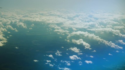 Aeroplane. View of airplane wing of aircraft flying above the clouds. 4K