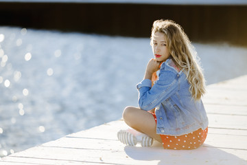 a girl with crossing feet sits on a berth