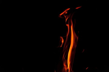 Red and orange fire flames isolated on black background, spooky shapes, large copy space