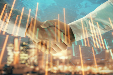Double exposure of financial chart and world map on cityscape background with two businessmen handshake. Concept of international investment