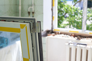 Part of the new plastic window in the foreground, installation of a plastic window, repair work.