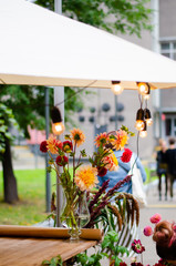 Floristry on the street. Making bouquets of flowers. Street festival.