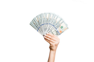 Female hand holding a fan of dollar banknotes on isolated background. Succes and investment concept