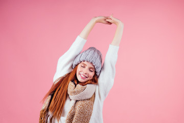 redhaired ginger woman yawning and stretching the body after winter sleeping in studio pink...