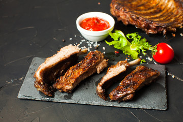 Roasted barbecue pork ribs on the black