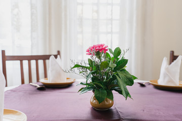 Fototapeta na wymiar Beautiful flowers in vase on table in restaurant.