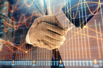 Multi exposure of forex graph on abstract background with two businessmen handshake. Concept of success on stock market