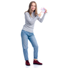 Woman in jeans and gray shirt holds alarm clock smiling standing on white background isolation