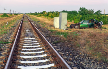 Obraz premium The car had an accident at a railway crossing. Passenger car collided with a train.