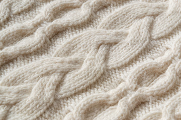 The closeup texture of cashmere things. Macro shot of knitted fabric from Lana Wool threads. Warm winter clothes. Background textile surface with copy space for text.