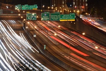 Downtown Atlanta highway with light trails during rush hour