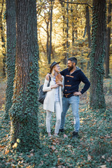 Fototapeta premium Intimate moments for happy lovers. Autumn and leaf fall Dreams. Romantic Autumn couple posing on nature background.