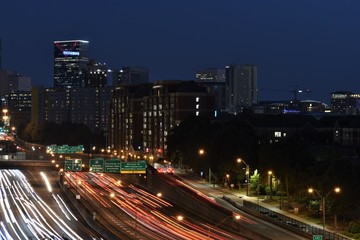 Downtown Atlanta highway with traffic light trails during early evening