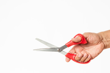 hand holding a tailor's red grips scissors isolated on white background