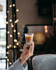 man holding a glass of coffee