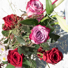 Bouquet of flowers with Deep Purple roses, Lilium Longiflorum, Chrysanthemum Santini, grasses, gypsophila and Red Naomi roses.