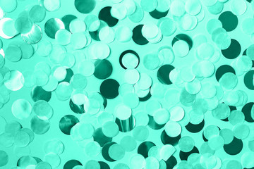 Festive background with round paper confetti in trendy mint color. Holiday concept. Copy space.