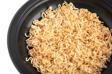 Instant noodles in a black Bowl. Isolated on white