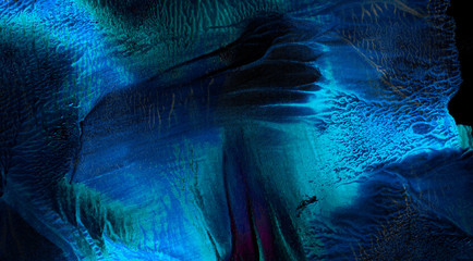 Bright light blue neon watercolor on deep black paper background. Aquarelle painted ink canvas for...