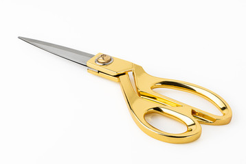 Golden scissors isolated on white background. Clipping path for artwork and design.