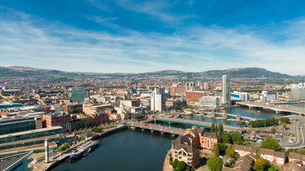 Obraz na płótnie Canvas Aerial view on river and buildings in City center of Belfast Northern Ireland. Drone photo, high angle view of town 
