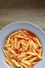 Plate of pasta with homemade tomato sauce. Flat lay.