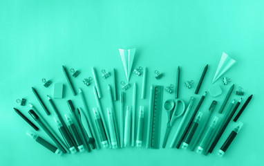 School supplies background in trendy mint color. Back to school concept. Flat lay. Copy space.