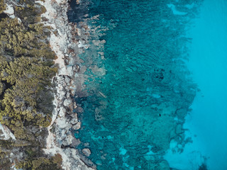 created by dji cameracliff bay at majorca with clean blue water