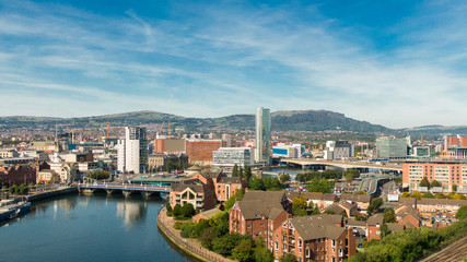 Obraz premium Aerial view on river and buildings in City center of Belfast Northern Ireland. Drone photo, high angle view of town 