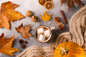 Thanksgiving background concept. Local produce pumpkin and autumn leaves with other decoration on textured table. Close up, copy space for text, top view, flat lay.