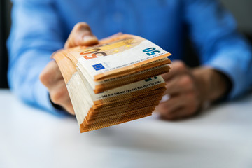 salary, money loan or prize concept - hand gives cash money