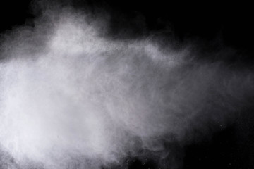 White powder explosion isolated on black background 