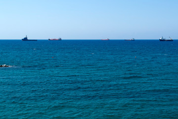 Panorama of blue sea with ships on horizon