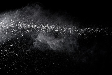 White powder explosion isolated on black background 