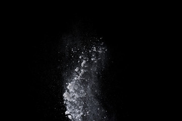 White powder explosion isolated on black background 