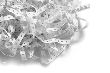 Pile of paper scrap dot matrix printer paper tear off edges on white background
