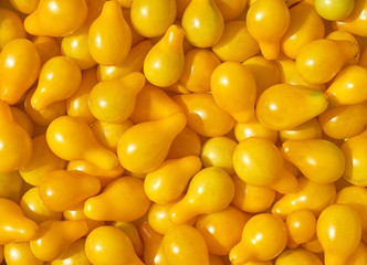 small yellow tomatoes of unusual shape background
