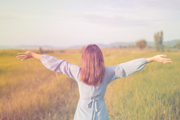 Beautiful young asian woman in the field pastel tone.