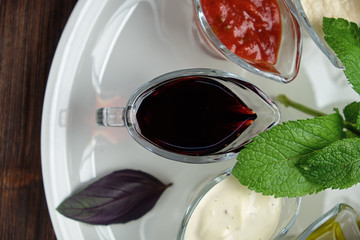 sauces in bowls on a dark wooden background. menu for catering