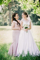 Bride and bridesmaid with a bouquet