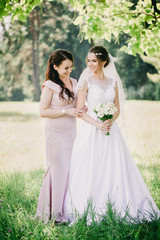 funny girls Bride and bridesmaid with a bouquet