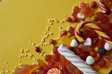 An assortment of colourful, festive sweets, lue marmalade in the shape of a heart on a blue...